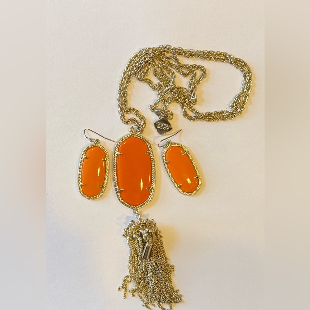 Kendra Scott gold with orange stone earring and pendant necklace set.